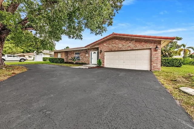 a view of a house with a yard and garage