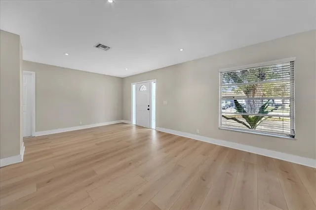 wooden floor in an empty room with a window
