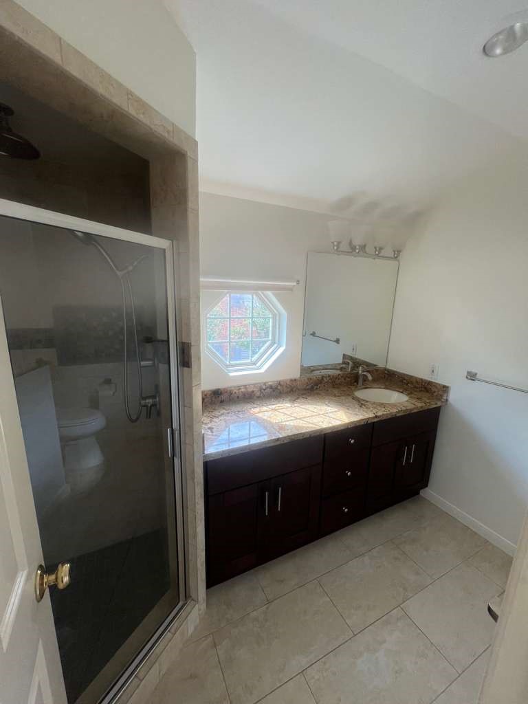 5817 Valley Forge Drive, Unit 90 Houston, TX 77057 - Photo 15 of 21 a spacious bathroom with a granite countertop sink and a mirror