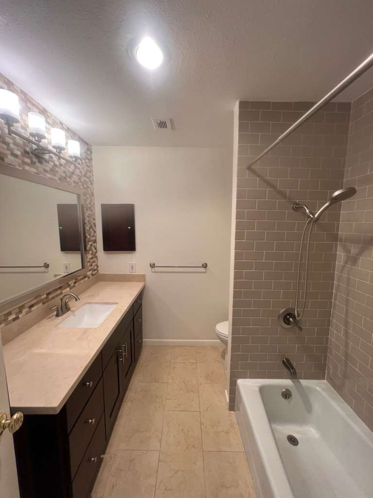 5817 Valley Forge Drive, Unit 90 Houston, TX 77057 - Photo 16 of 21 a bathroom with a tub a sink double vanity and mirror
