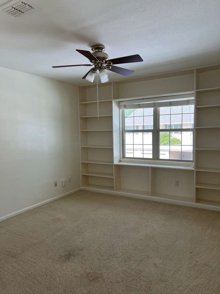 5817 Valley Forge Drive, Unit 90 Houston, TX 77057 - Photo 19 of 21 an empty room with a ceiling fan and window