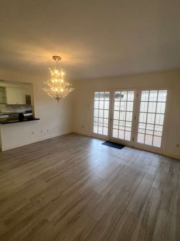 5817 Valley Forge Drive, Unit 90 Houston, TX 77057 - Photo 6 of 21 wooden floor in an empty room with a window