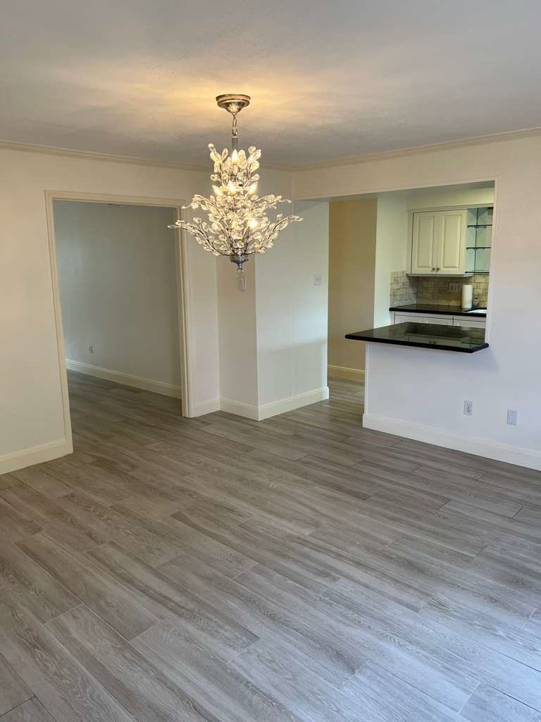 5817 Valley Forge Drive, Unit 90 Houston, TX 77057 - Photo 7 of 21 a view of a kitchen with a sink and dishwasher wooden floor