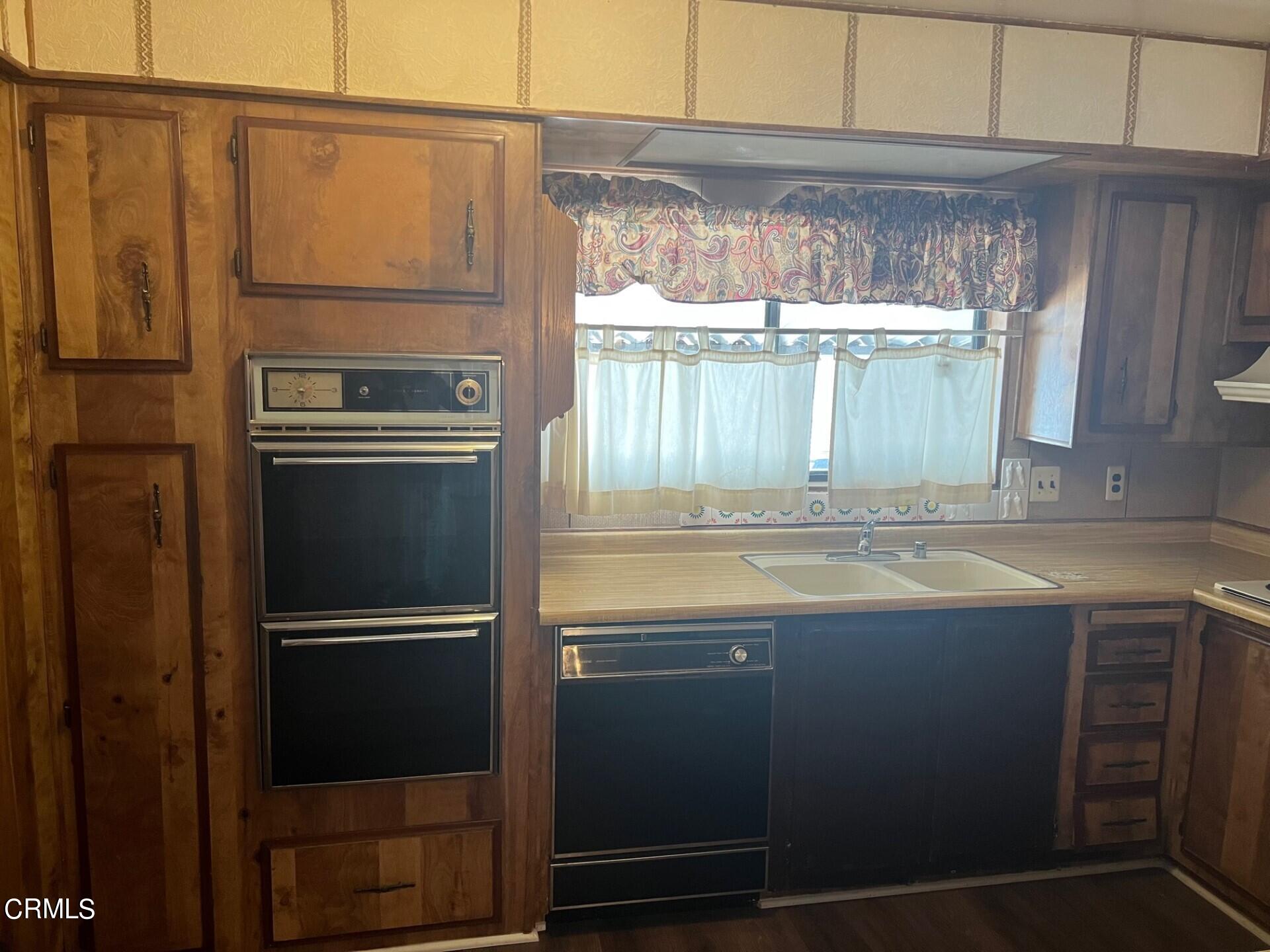 3700 Olds Road, Unit 86 Oxnard, CA 93033 - Photo 4 of 12 a kitchen with granite countertop a refrigerator and a sink