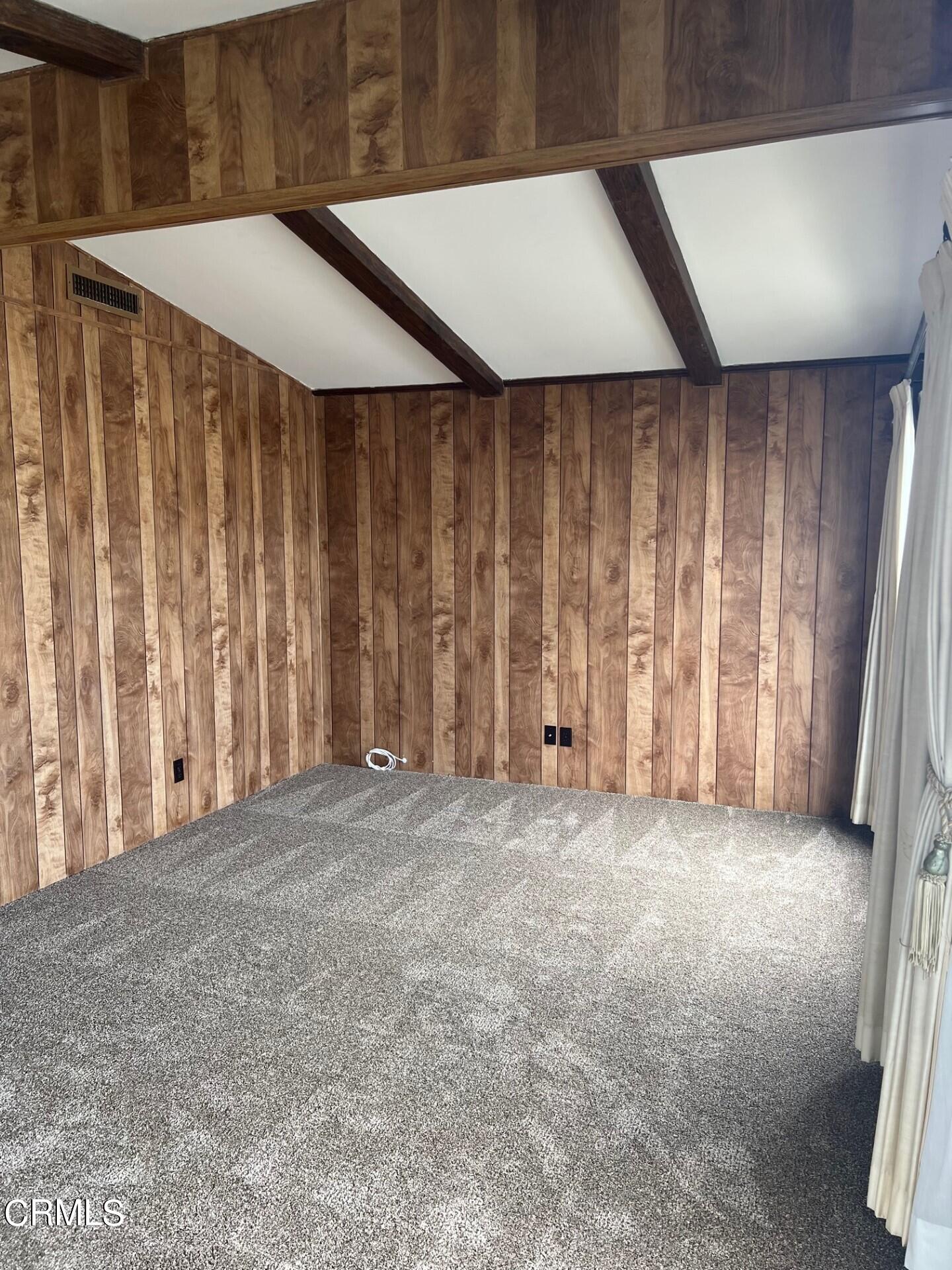 3700 Olds Road, Unit 86 Oxnard, CA 93033 - Photo 8 of 12 an empty room with wooden walls and windows