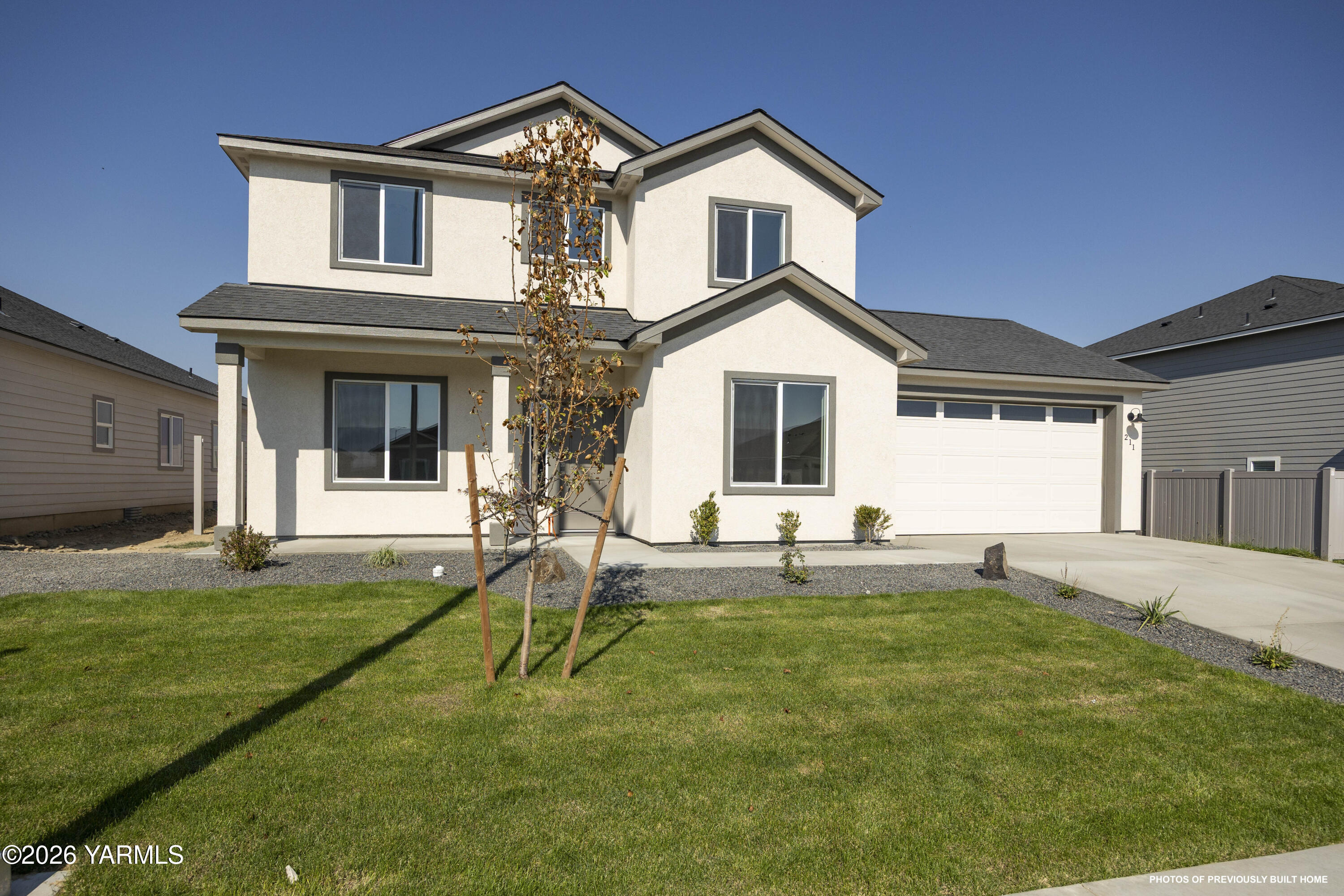 215 Packer Street Prosser, WA 99350 - Photo 25 of 38 a view of a house with a yard and a patio