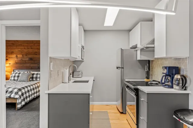 a kitchen with stainless steel appliances a sink a stove and a refrigerator
