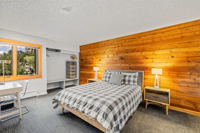 a bedroom with a bed chair and window