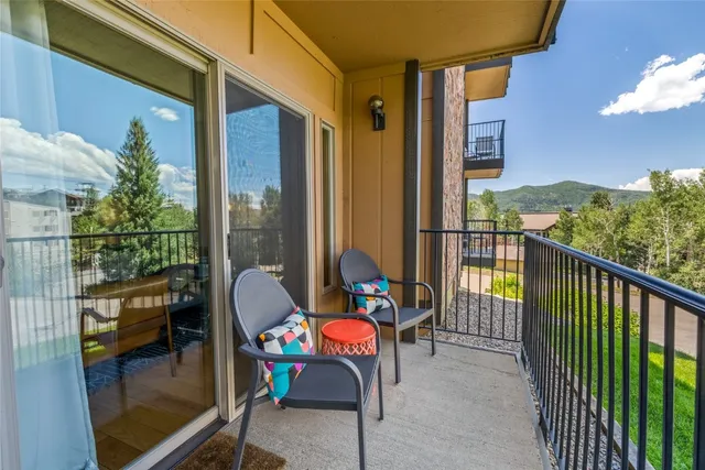 a balcony with chairs and a table