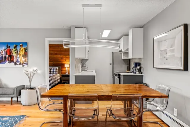 a dining table with chairs and window