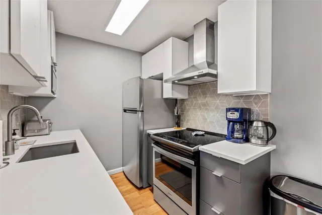 a kitchen with a stove sink and refrigerator