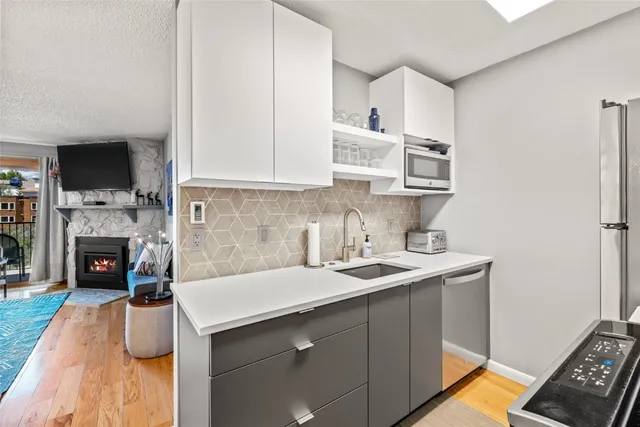 a kitchen with stainless steel appliances a sink a stove and a refrigerator