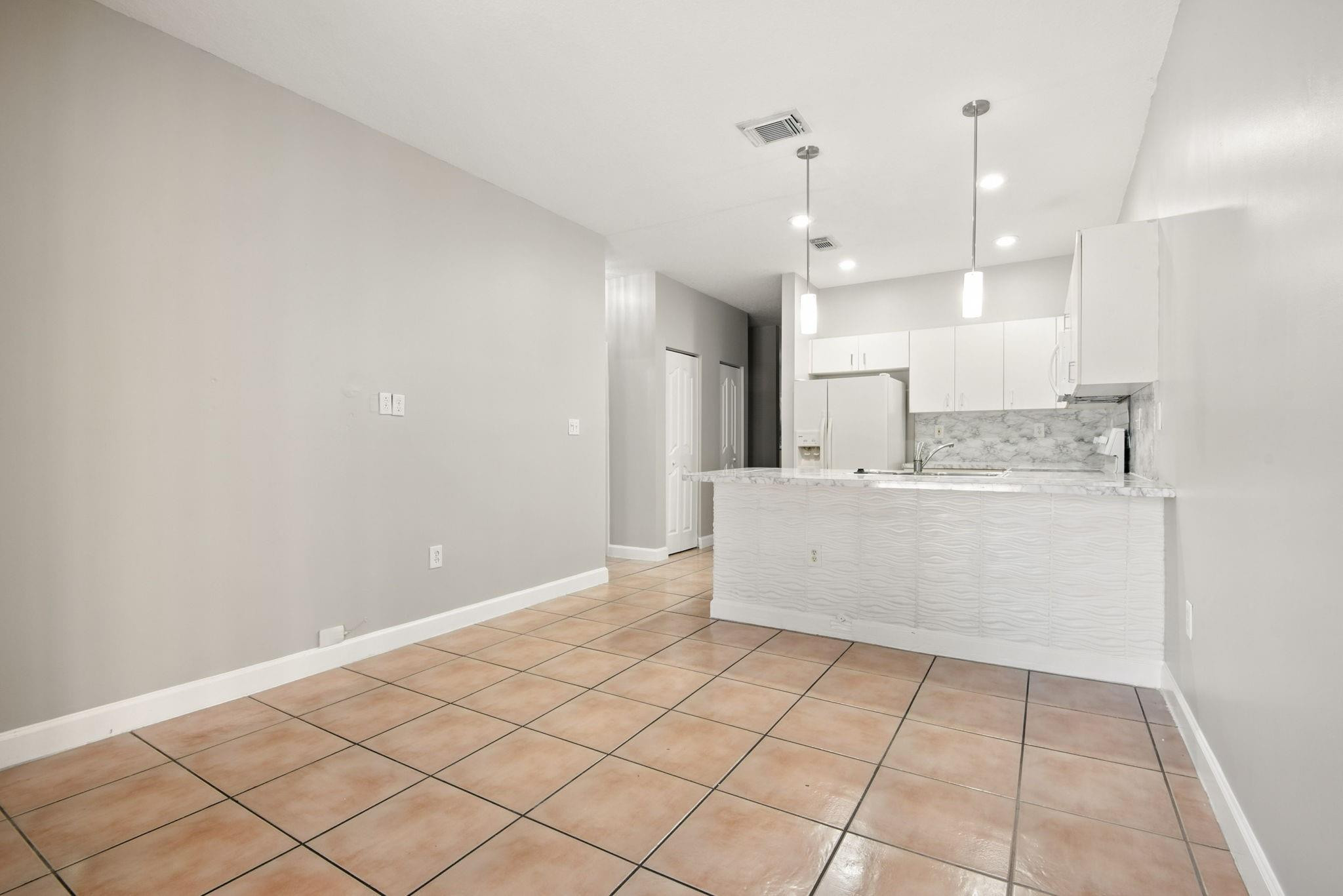 11368 Southwest 230th Terrace Miami, FL 33170 - Photo 16 of 37 a large white kitchen with a large window