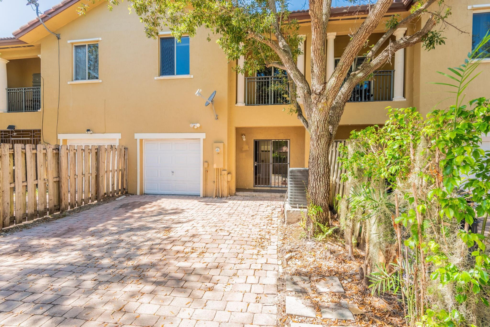11368 Southwest 230th Terrace Miami, FL 33170 - Photo 34 of 37 a yellow house with trees in front of it