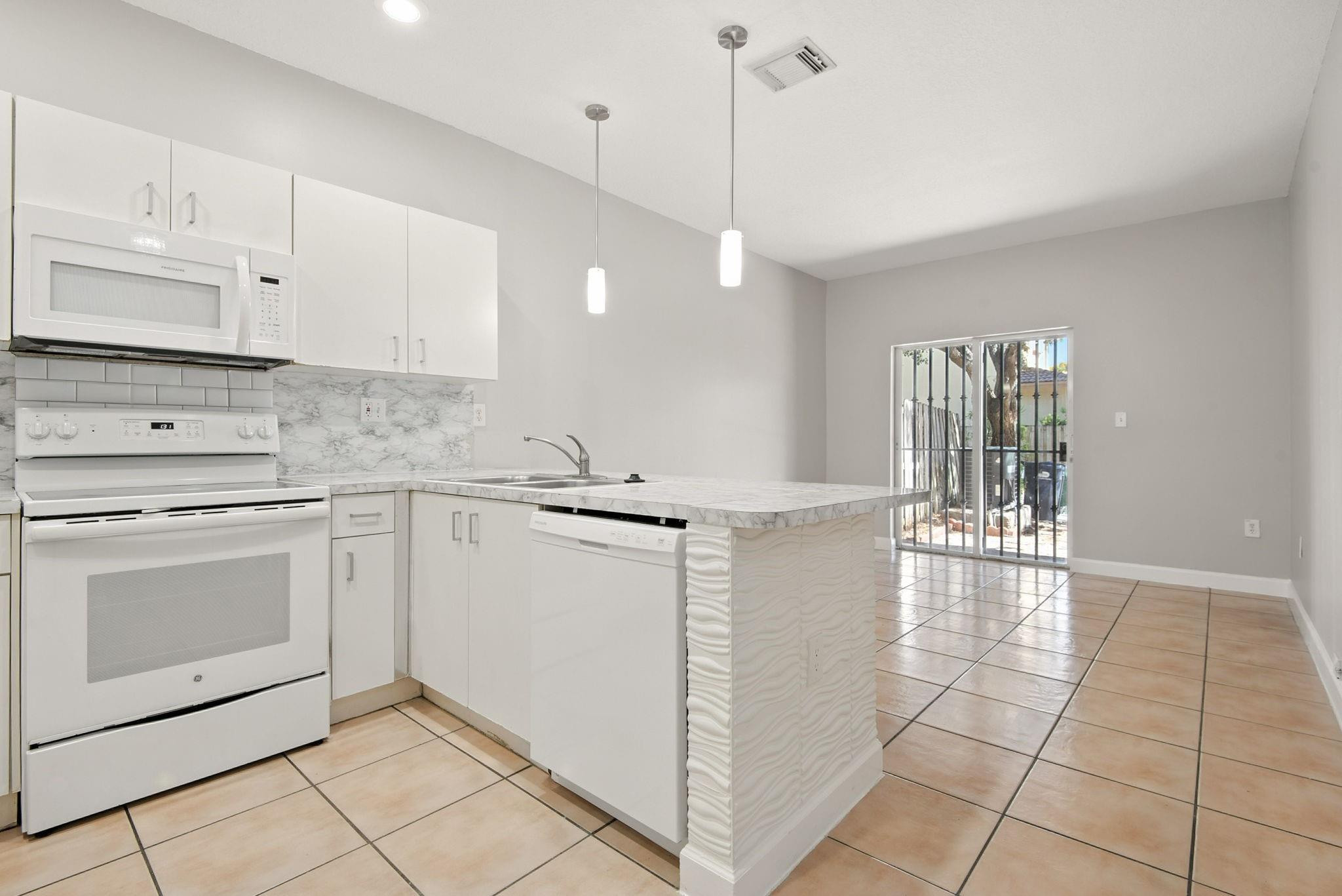 11368 Southwest 230th Terrace Miami, FL 33170 - Photo 8 of 37 a kitchen with a sink cabinets and window