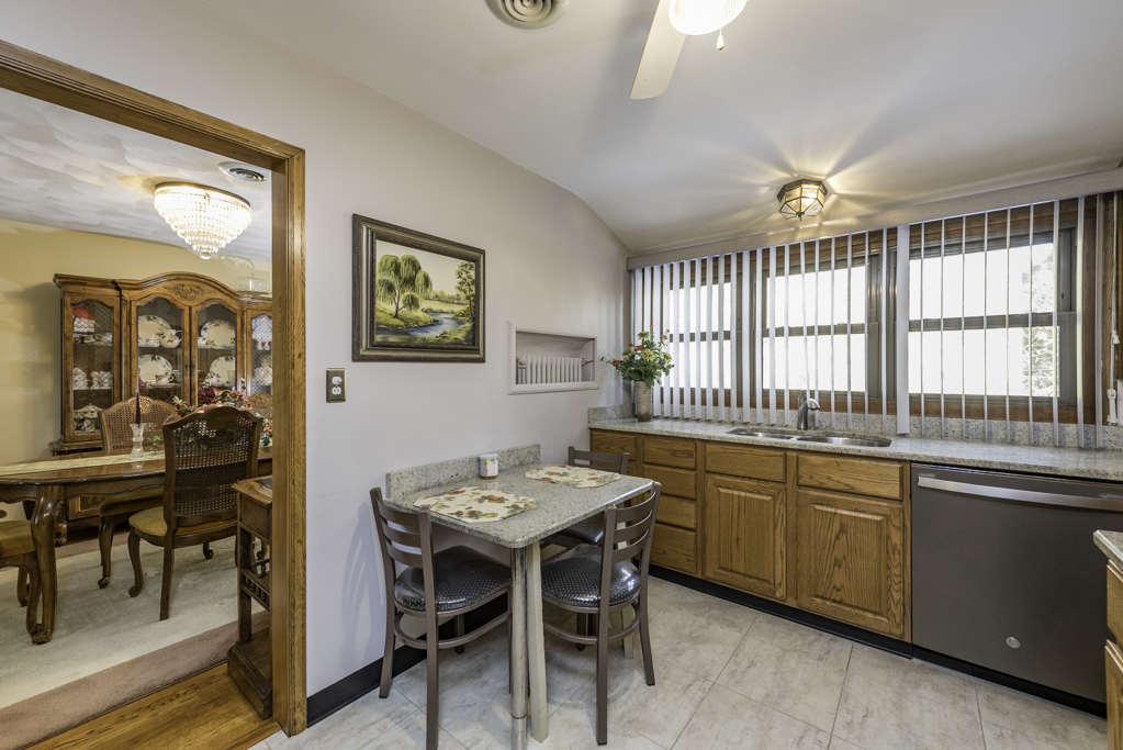 1118 Shiloh Boulevard Zion, IL 60099 - Photo 14 of 33 a view of a dining room with furniture window and wooden floor