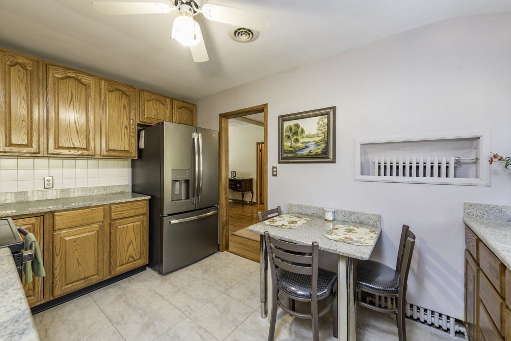 1118 Shiloh Boulevard Zion, IL 60099 - Photo 15 of 33 a kitchen with stainless steel appliances granite countertop a refrigerator a stove a sink dishwasher with a dining table and chairs