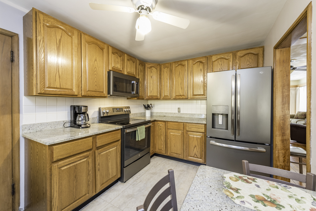 1118 Shiloh Boulevard Zion, IL 60099 - Photo 16 of 33 a kitchen with stainless steel appliances granite countertop a refrigerator sink and cabinets