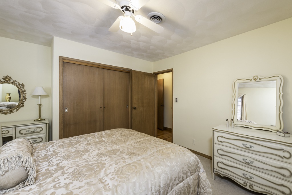 1118 Shiloh Boulevard Zion, IL 60099 - Photo 18 of 33 a bedroom with a bed and a chandelier