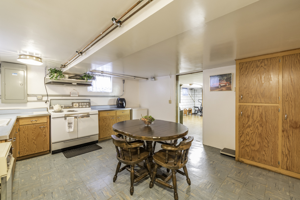 1118 Shiloh Boulevard Zion, IL 60099 - Photo 26 of 33 a kitchen with a table chairs refrigerator and cabinets