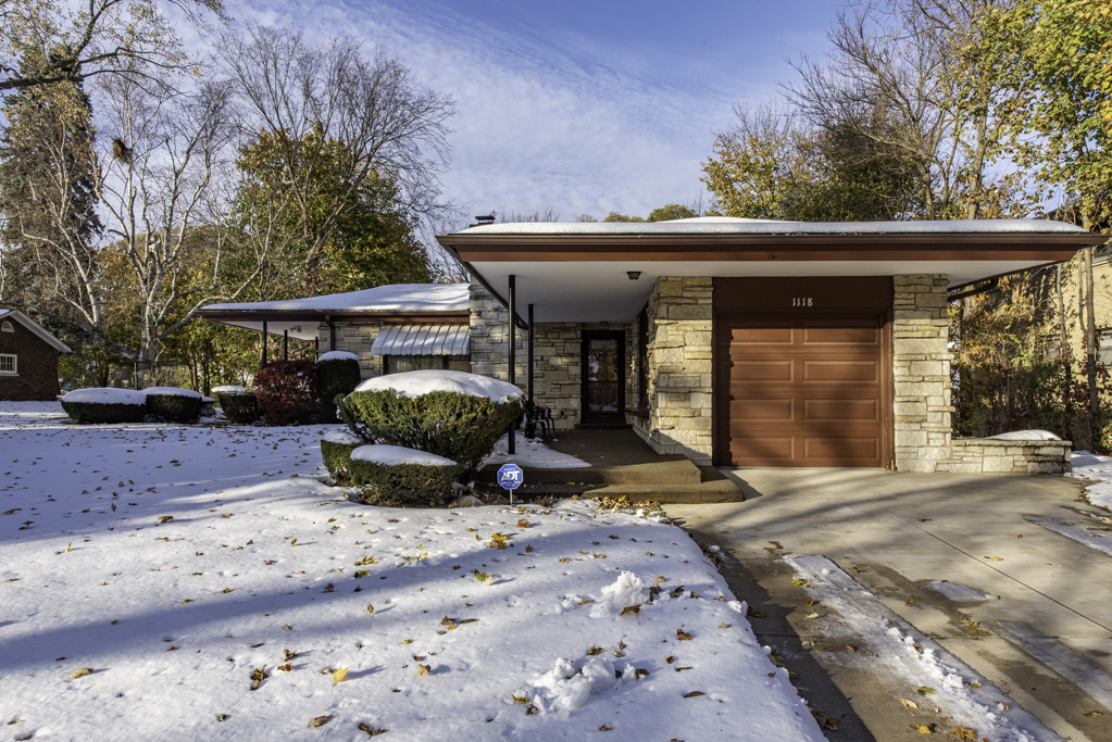 1118 Shiloh Boulevard Zion, IL 60099 - Photo 4 of 33 a view of a patio with a table and chairs under an umbrella