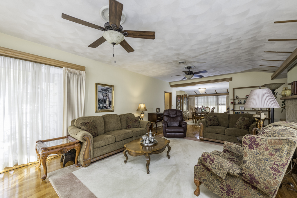 1118 Shiloh Boulevard Zion, IL 60099 - Photo 8 of 33 a living room with furniture ceiling fan and a window