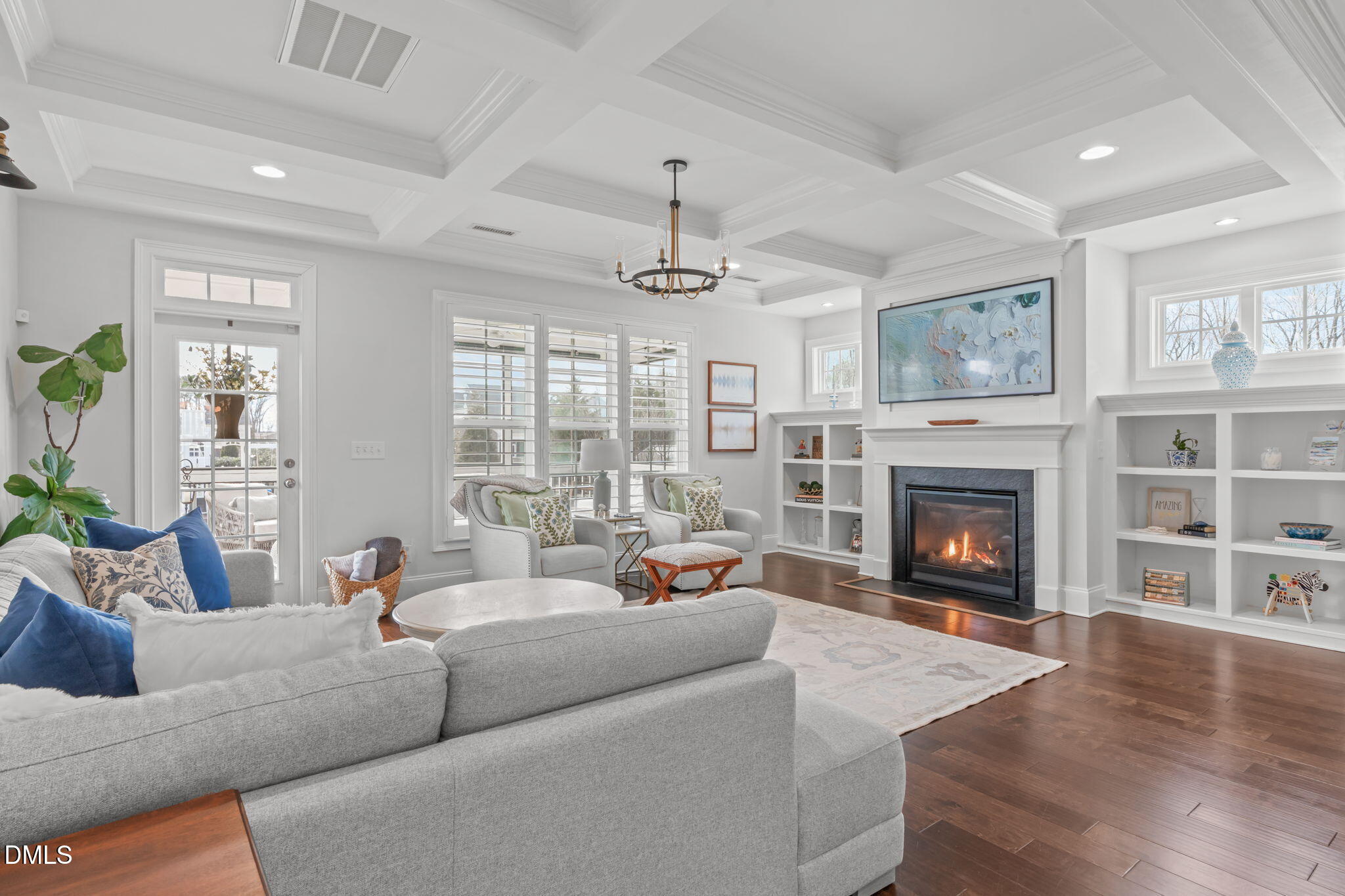 4144 Olde Judd Drive Willow Spring, NC 27592 - Photo 12 of 52 a living room with furniture a chandelier and a fireplace