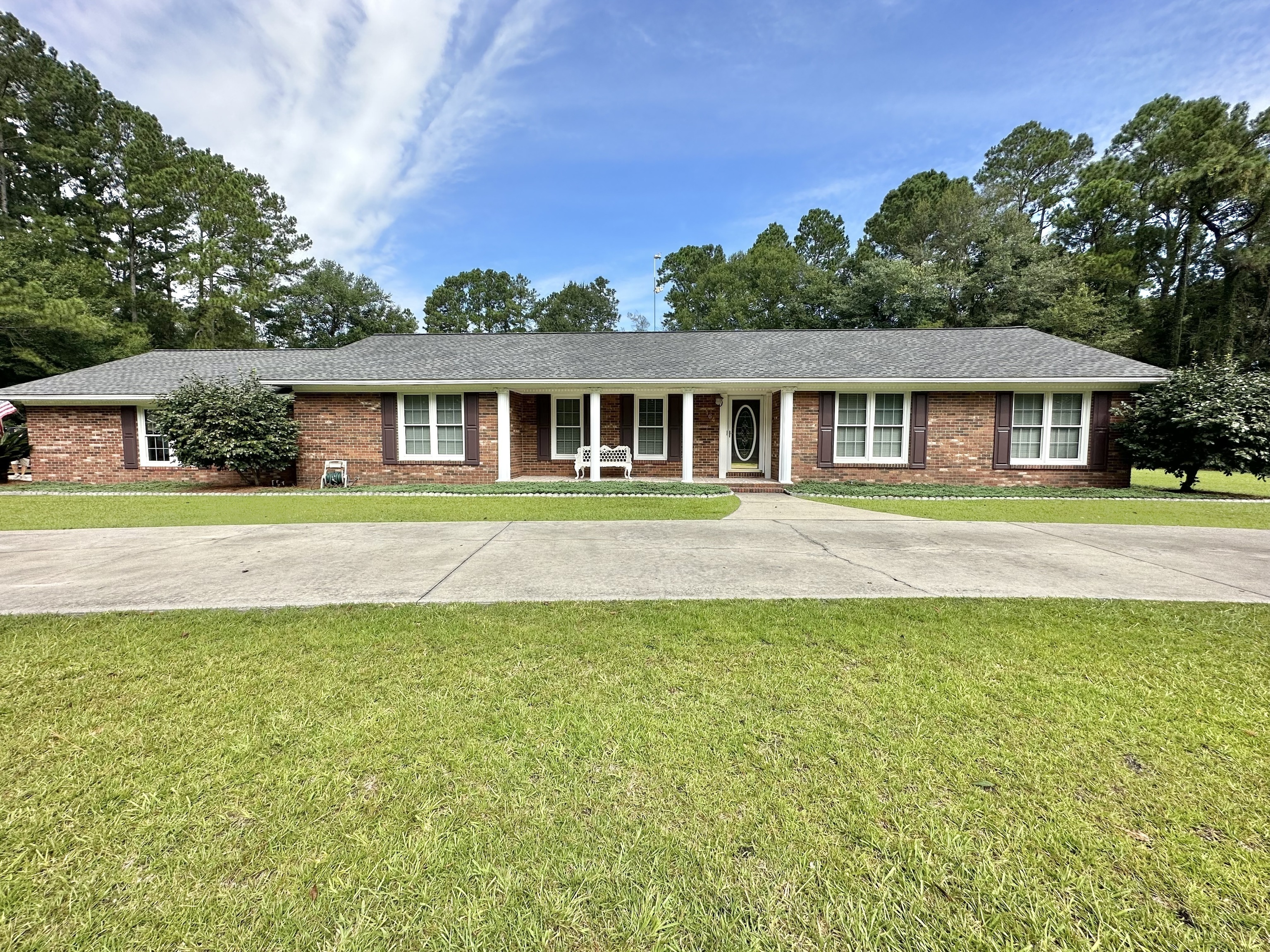 164 1st Road Hazlehurst, GA 31539 - Photo 1 of 1 a front view of a house with a garden and trees