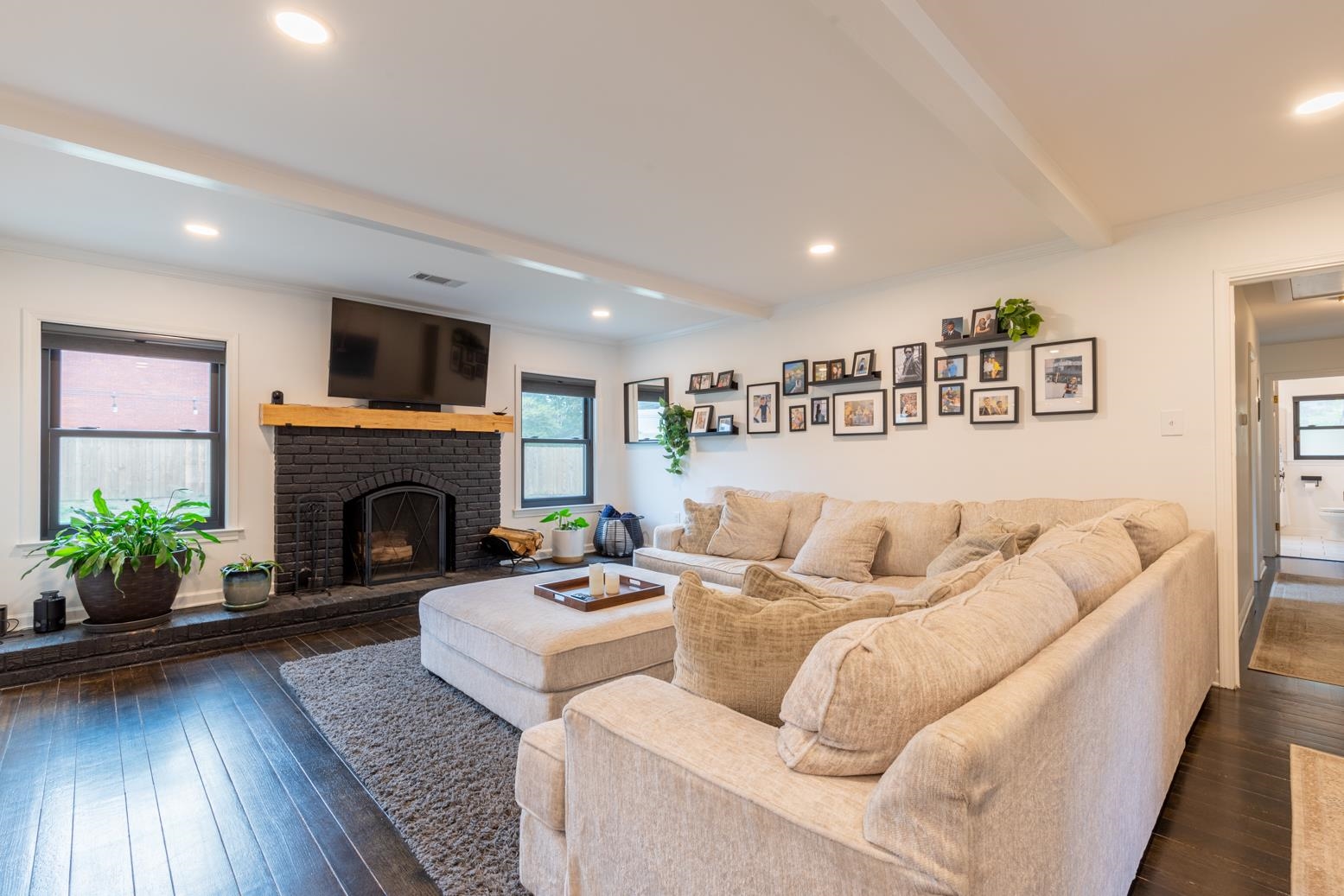 6270 Quince Road Memphis, TN 38119 - Photo 14 of 28 Den featuring dark wood-type flooring, beam ceiling, and a fireplace