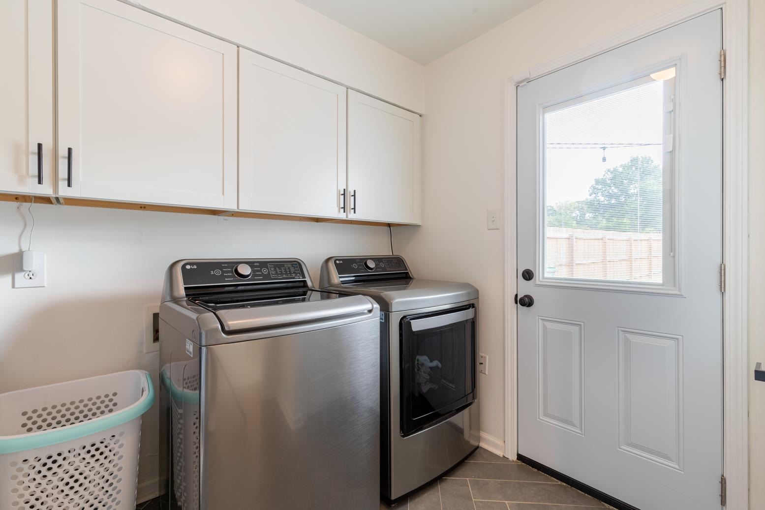 6270 Quince Road Memphis, TN 38119 - Photo 23 of 28 Washroom featuring cabinets, washer and clothes dryer, and tile patterned floors