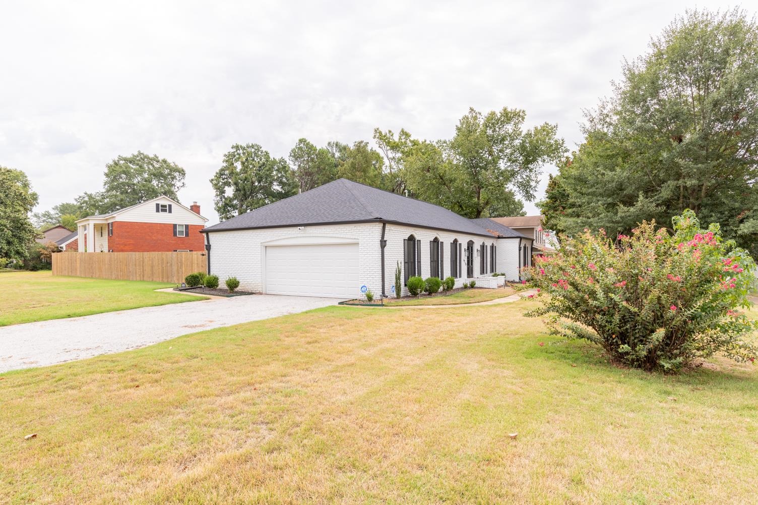 6270 Quince Road Memphis, TN 38119 - Photo 26 of 28 View of side of home with a lawn and a garage