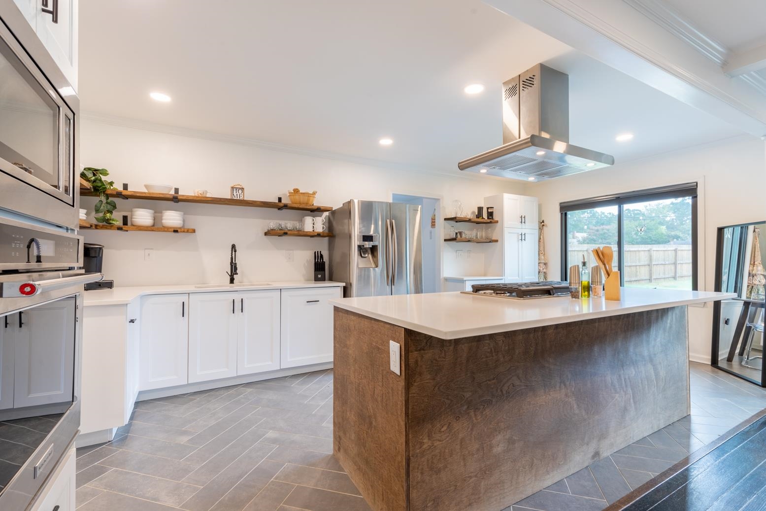 6270 Quince Road Memphis, TN 38119 - Photo 7 of 28 Kitchen featuring a kitchen island, appliances with stainless steel finishes, island exhaust hood, ornamental molding, and sink