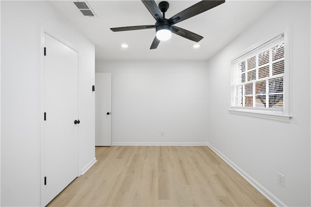 2095 Mulkey Road Southwest Marietta, GA 30008 - Photo 21 of 32 an empty room with a window and ceiling fan