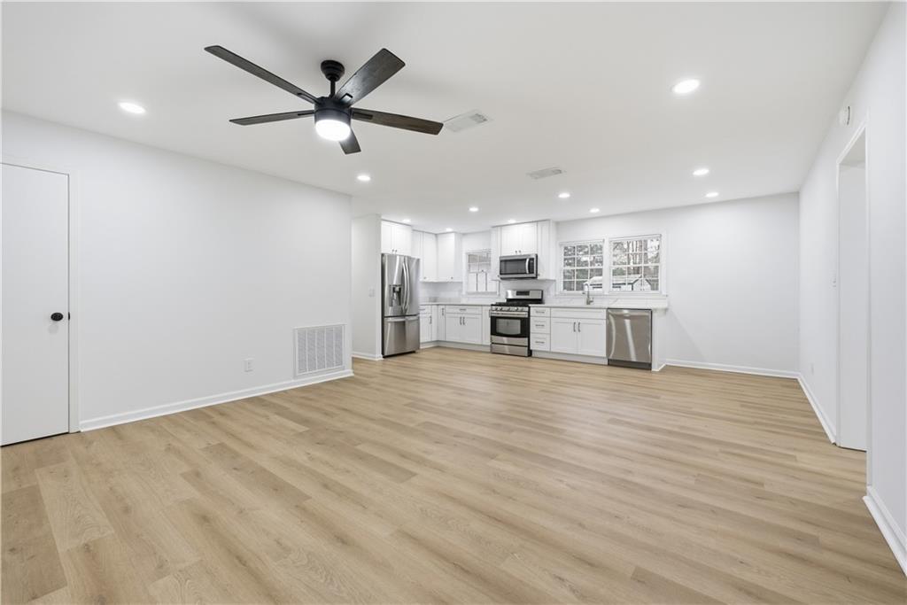 2095 Mulkey Road Southwest Marietta, GA 30008 - Photo 8 of 32 a view of empty room with wooden floor and ceiling fan