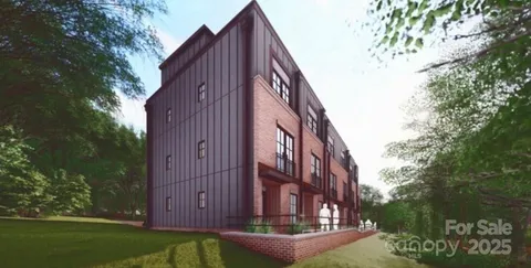 a view of a tall building with a yard