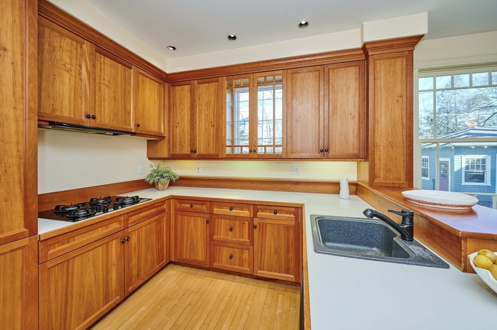 32 Lenox Street Newton, MA 02465 - Photo 13 of 36 a kitchen with stainless steel appliances granite countertop a stove a sink and a microwave
