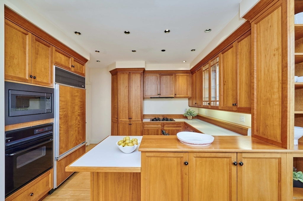 32 Lenox Street Newton, MA 02465 - Photo 14 of 36 a kitchen with a stove a sink and a refrigerator