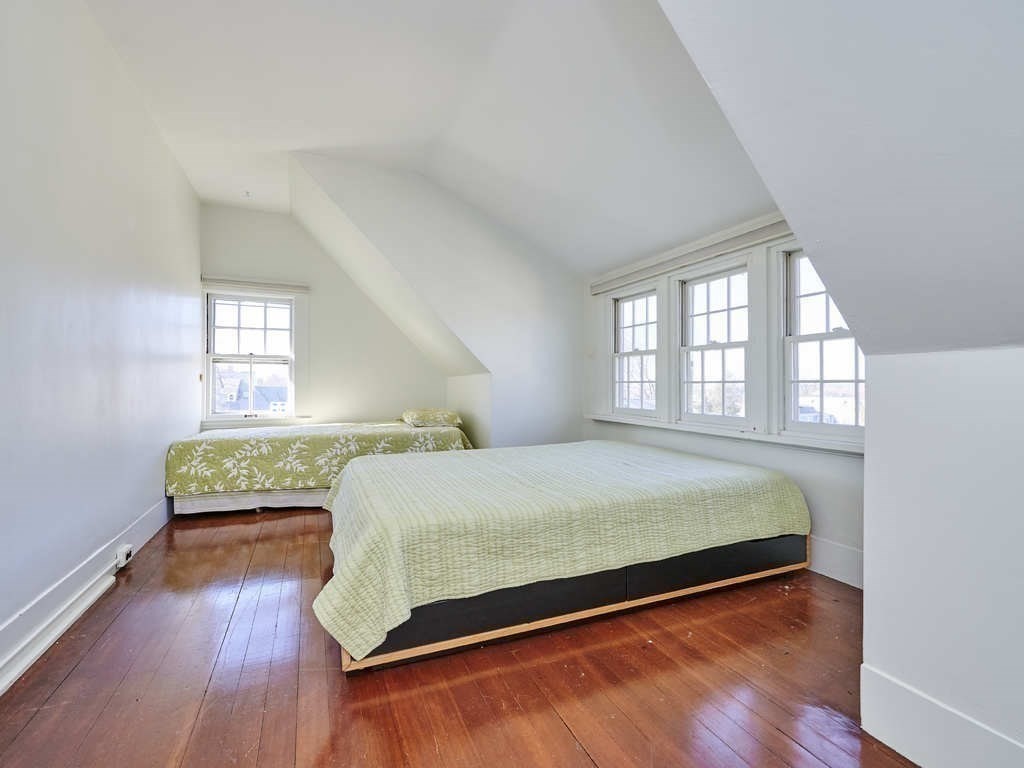 32 Lenox Street Newton, MA 02465 - Photo 30 of 36 a bed sitting in a bedroom next to a window