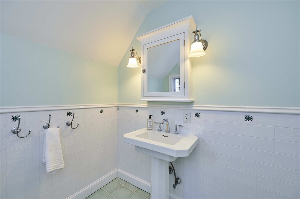 32 Lenox Street Newton, MA 02465 - Photo 31 of 36 a bathroom with a sink and a mirror