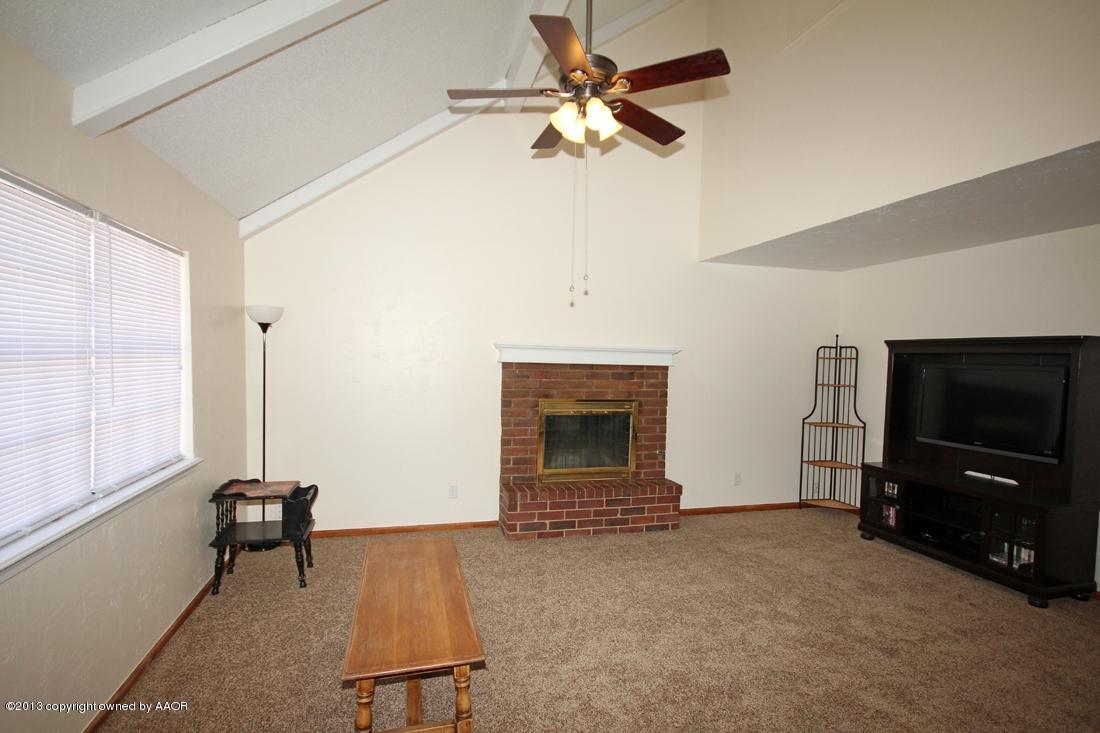 5216 Leland Drive Amarillo, TX 79110 - Photo 2 of 23 a living room with furniture and a flat screen tv