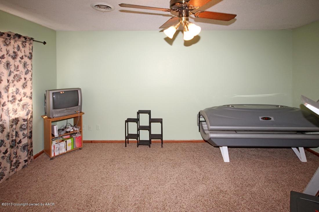 5216 Leland Drive Amarillo, TX 79110 - Photo 12 of 23 a room with a baby bed and a chandelier