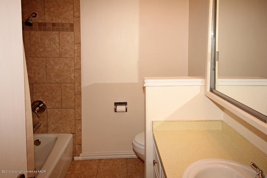 5216 Leland Drive Amarillo, TX 79110 - Photo 13 of 23 a bathroom with a shower and toilet