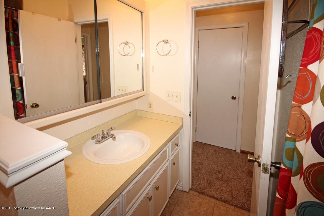 5216 Leland Drive Amarillo, TX 79110 - Photo 14 of 23 a bathroom with a sink and a mirror
