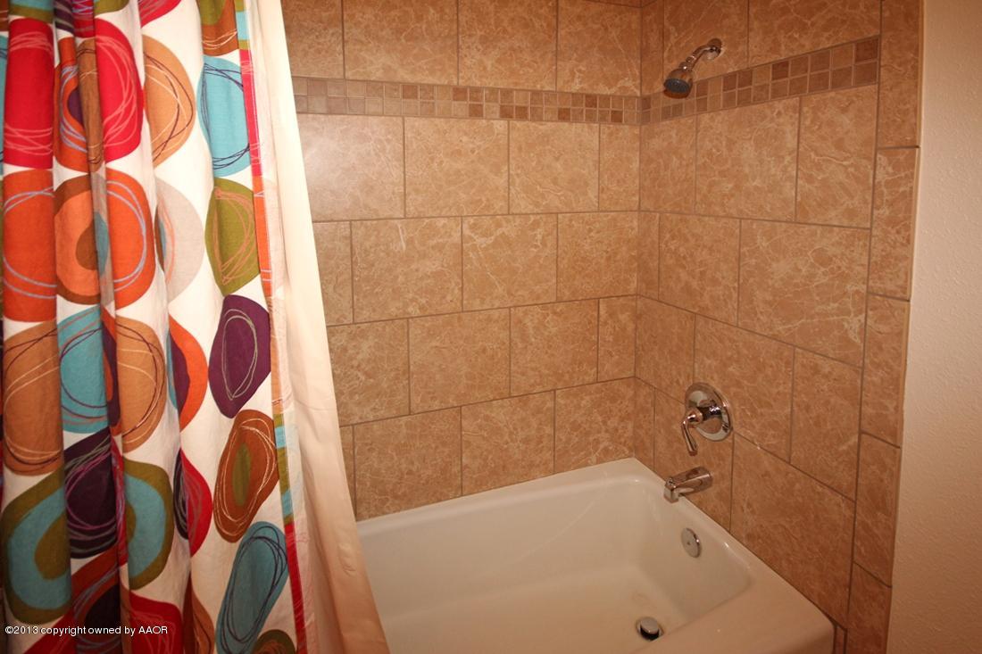 5216 Leland Drive Amarillo, TX 79110 - Photo 15 of 23 a bathroom with a bathtub and shower