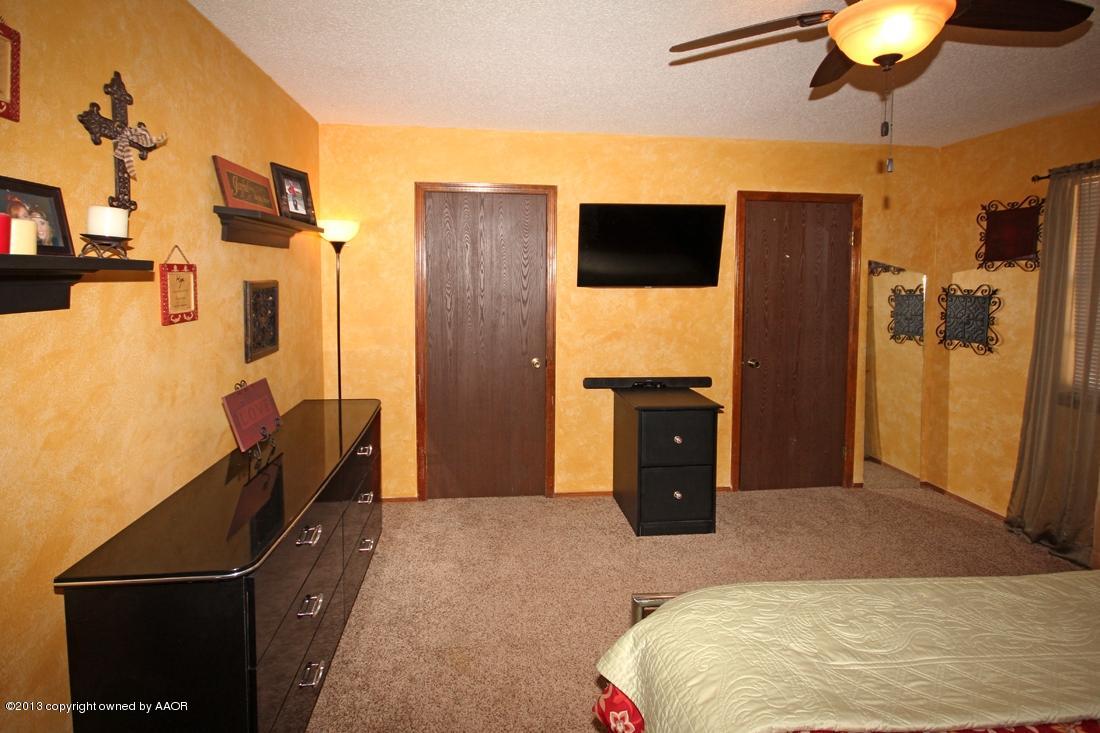 5216 Leland Drive Amarillo, TX 79110 - Photo 18 of 23 a bedroom with a bed and a television