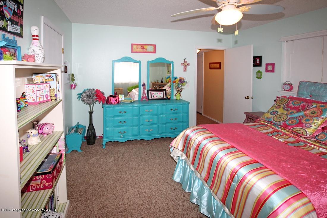 5216 Leland Drive Amarillo, TX 79110 - Photo 20 of 23 a bed room with a bed and a baby bed