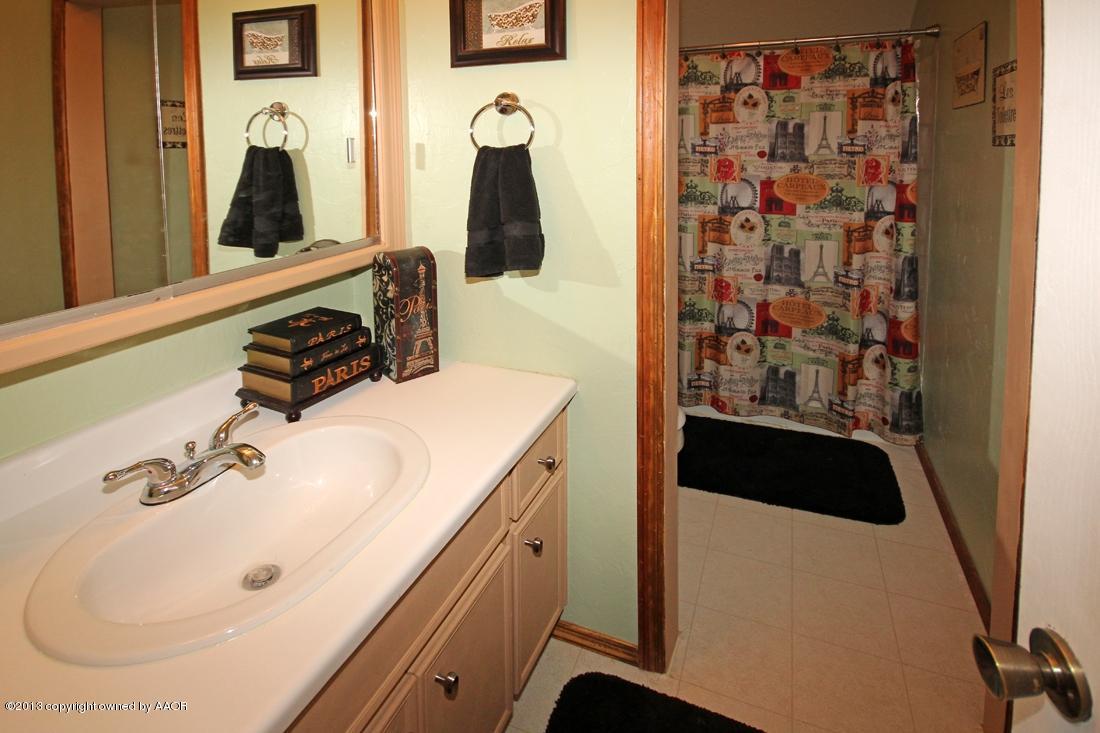 5216 Leland Drive Amarillo, TX 79110 - Photo 21 of 23 a bathroom with a sink and mirror