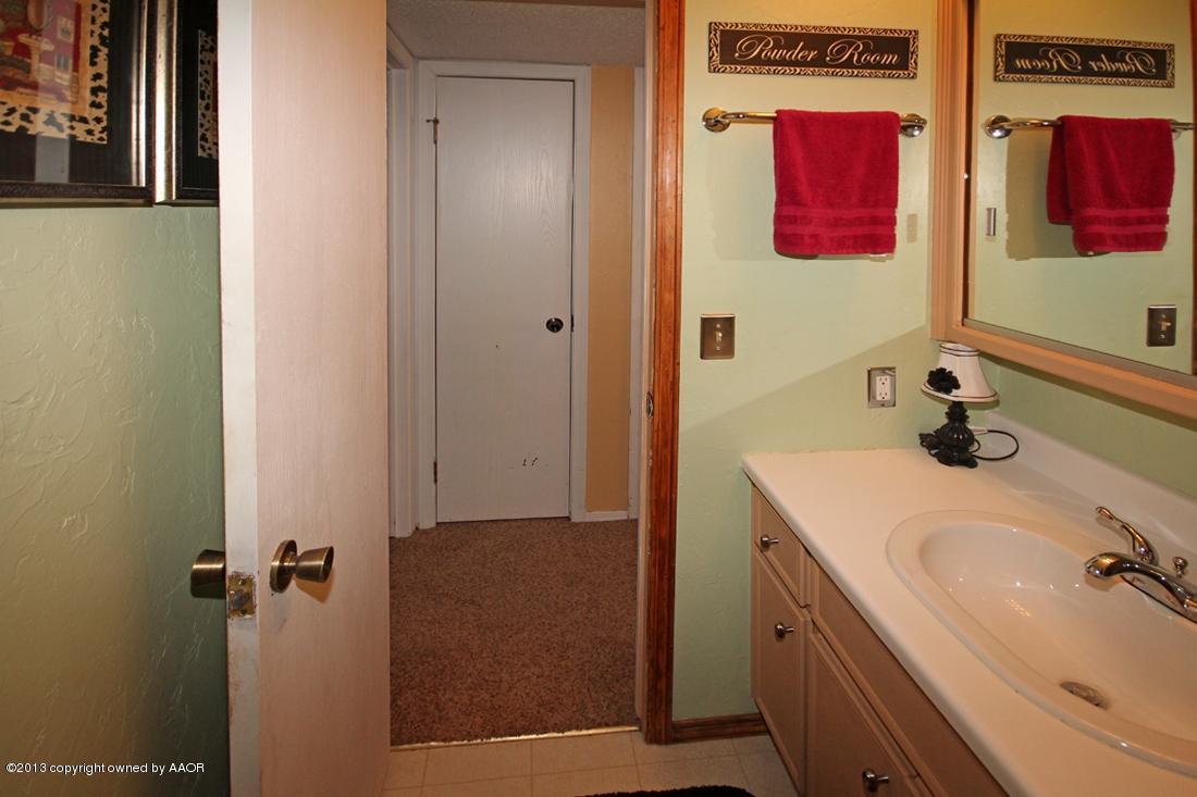 5216 Leland Drive Amarillo, TX 79110 - Photo 23 of 23 a bathroom with a sink and a mirror