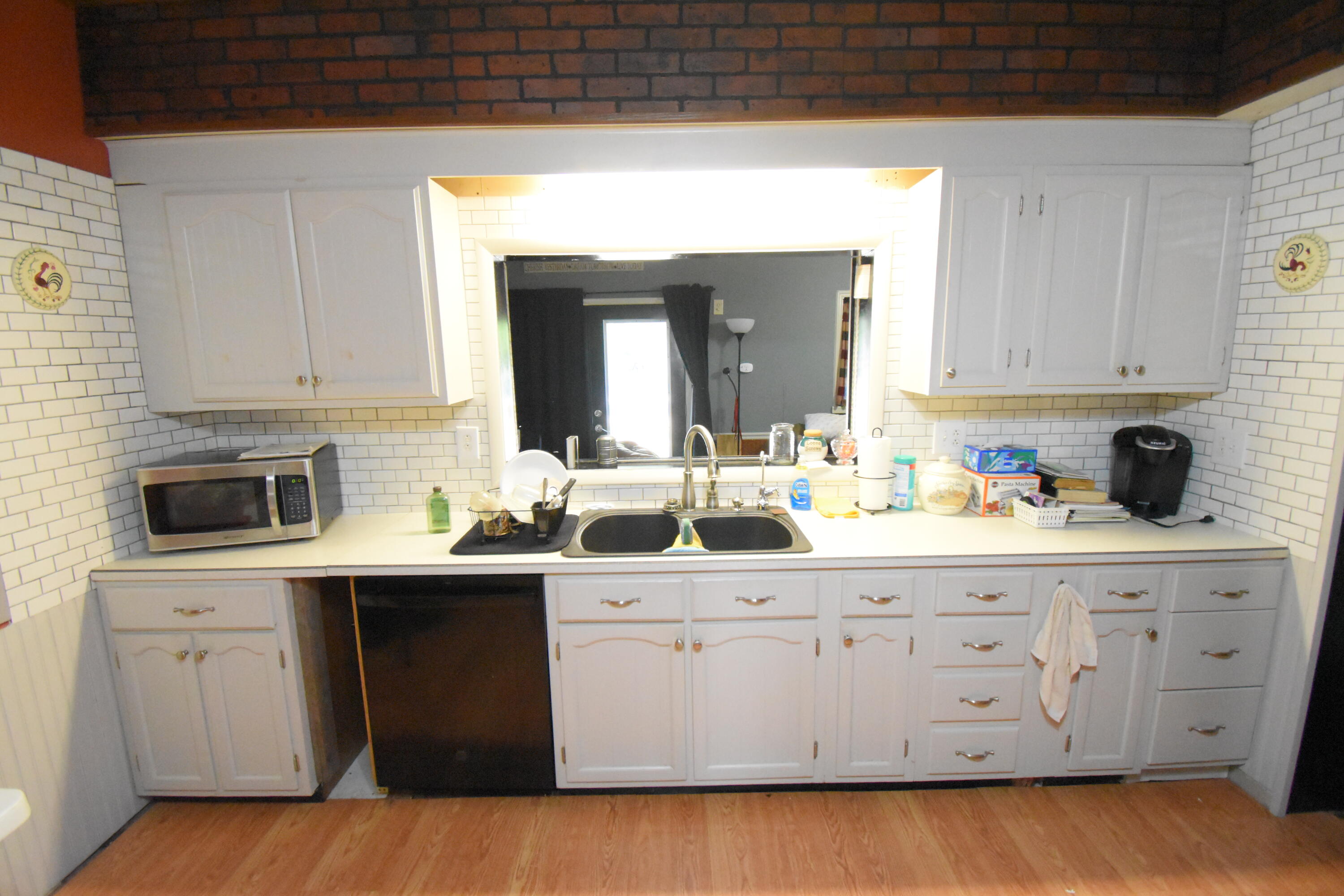 522 North Cullen Street Rensselaer, IN 47978 - Photo 12 of 43 a kitchen with white cabinets sink and white appliances