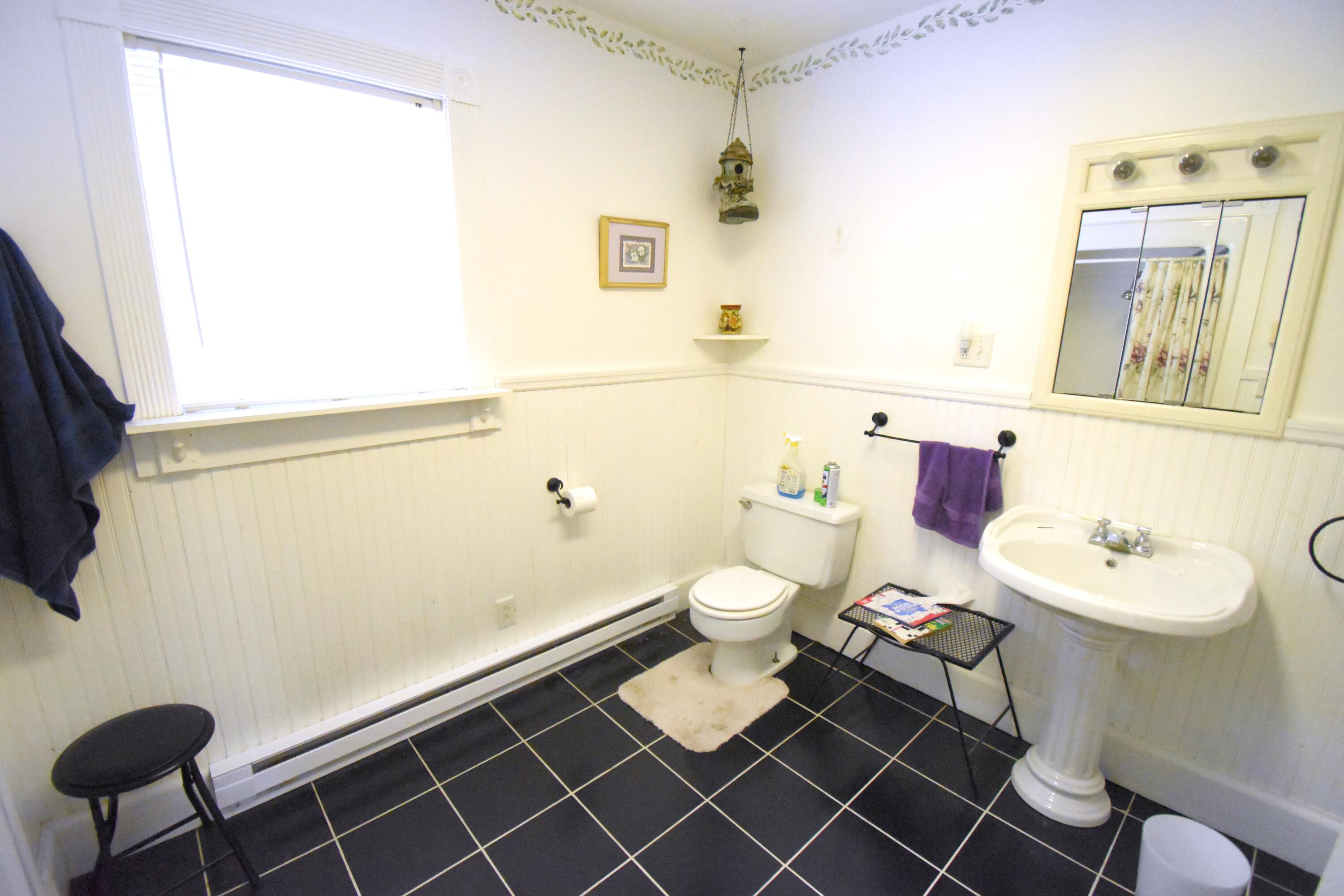 522 North Cullen Street Rensselaer, IN 47978 - Photo 30 of 43 a bathroom with a sink a toilet and a mirror